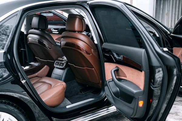 Car interior panels and seating suggest use of coatings and adhesives in assembly