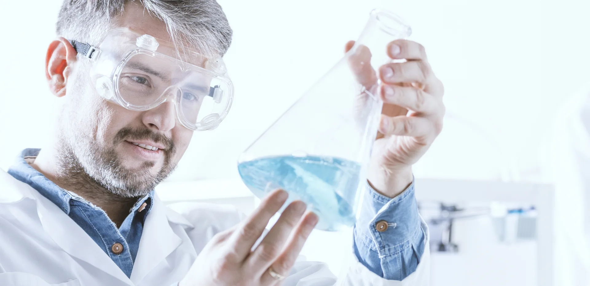 Flask containing blue liquid used for resin or coating evaluation